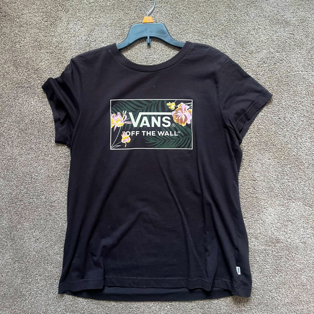 Black tee with design on front.